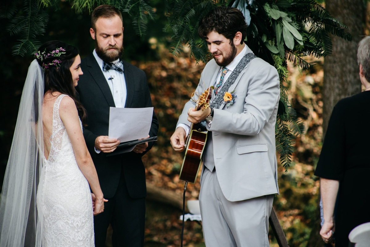 groom singing song during ceremony